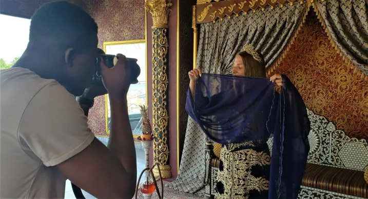 camera pointed at a lady with a veil in front of her face at a Photoshoot at Taht Istanbul Turkey