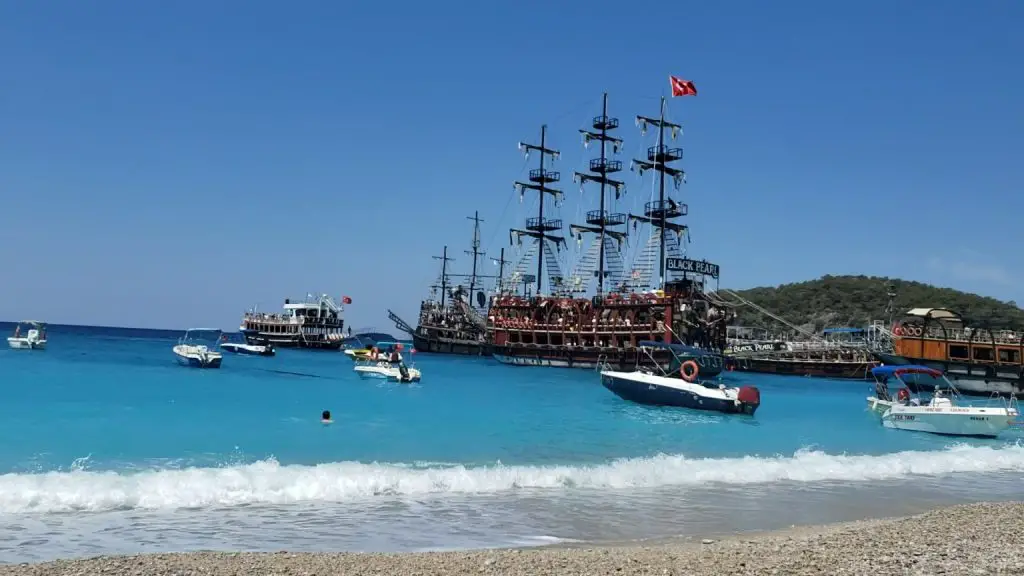 Blue sea with waves and Pirate Ship Tour at Oludeniz Beach near Fethiye
