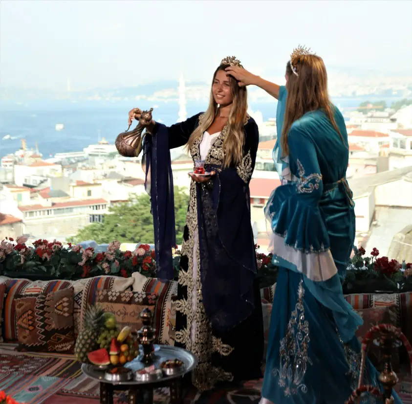 mother fixing daughters hair at a photo shoot on a rooftop in Istanbul
