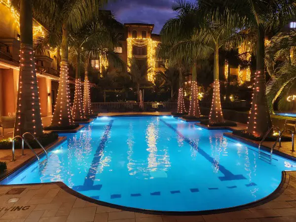 deep blue pool water with twinkling lights of the luxury Mestil Hotel in Kampala