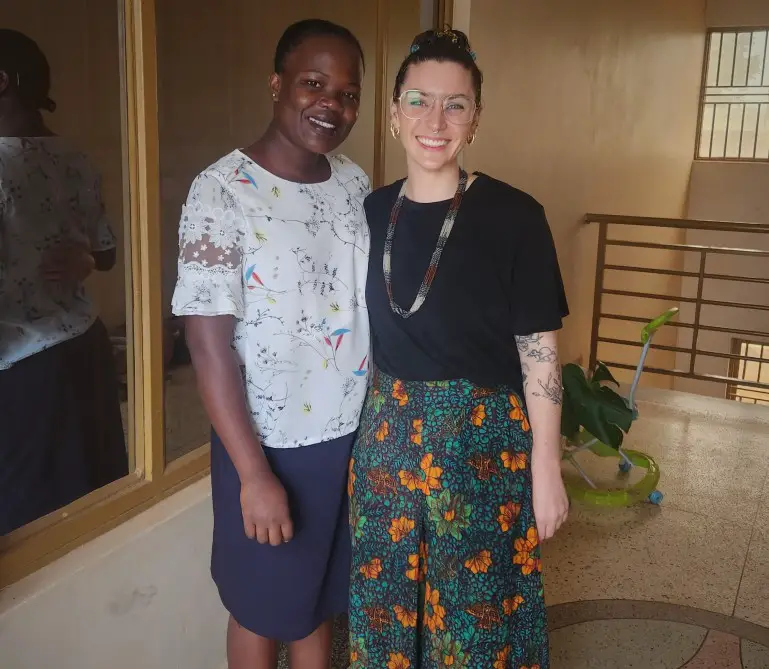 2 ladies standing together in the hallway - Mia and Marion from Girls Up non profit