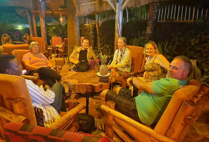 people sitting around a table getting ready to go on a safari