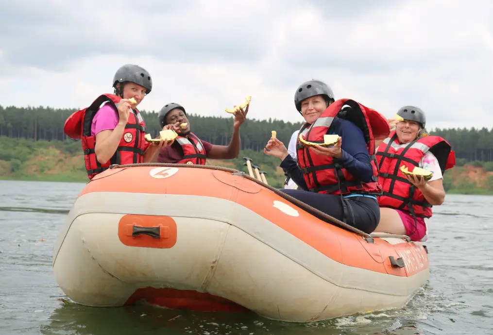 sitting in the raft boat eating pineapple