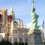 thrill ride big apple coaster at a casino in Las Vegas with statue of liberty in the background