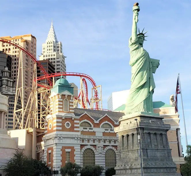 thrill ride big apple coaster at a casino in Las Vegas with statue of liberty in the background