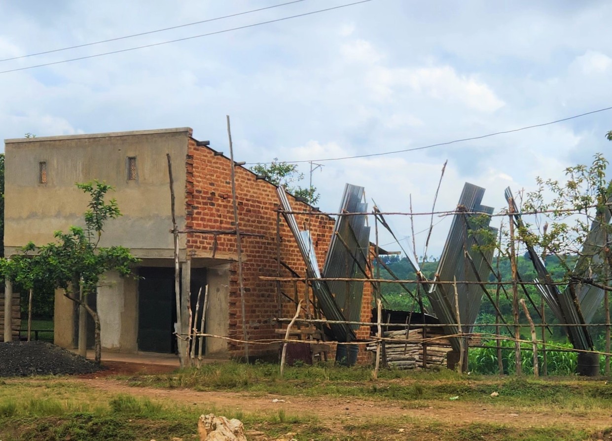 metal tins beside an old building in a Uganda town - this is how they catch grasshoppers