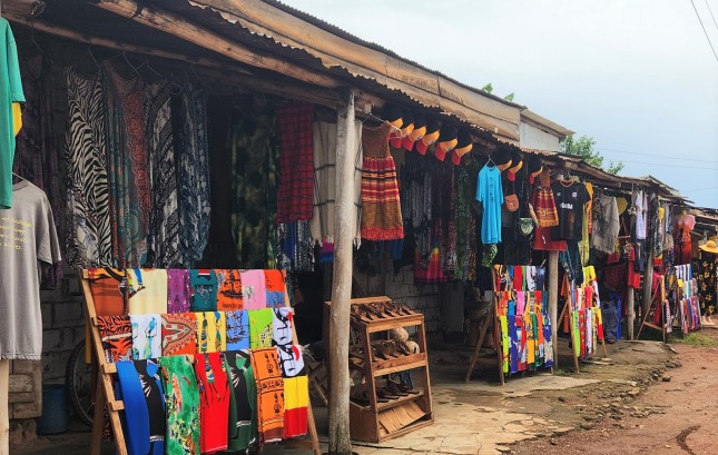 souvenir shops in Uganda with displays of colorful clothing hanging up