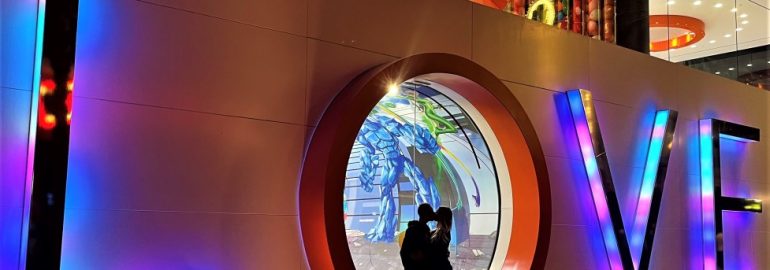 shadow of couple kissing in neon LOVE letters in Las Vegas
