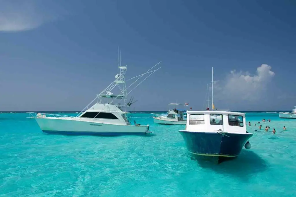 boats in the clean blue water of the Cayman Islands Caribbean bucket list destination