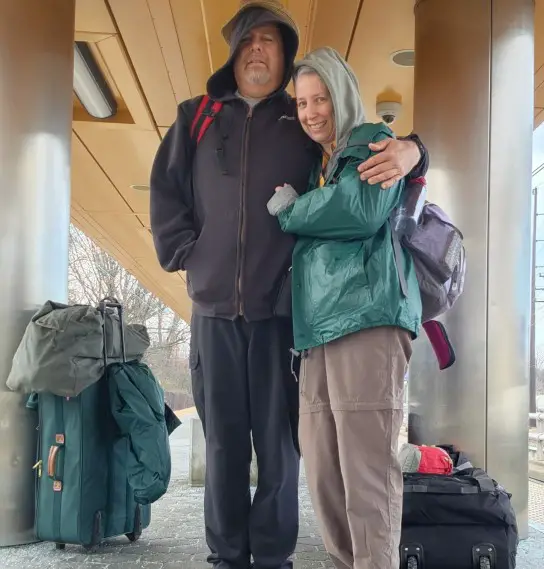 couple hugging in front of their Luggage for a trip to Uganda