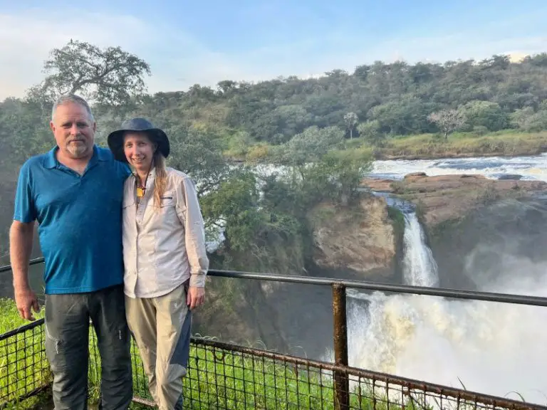 couple standing in front of a waterfall in Uganda