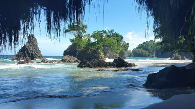 rocks in the distance in the water at Paria Bay in Trinidad and Tobago