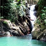man jumping into waterfall in Trinidad and Tobago