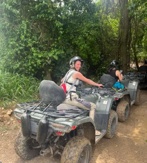 lady facing away from camera on an adventure on an atv with helmet in the jungle in Puerto Rico