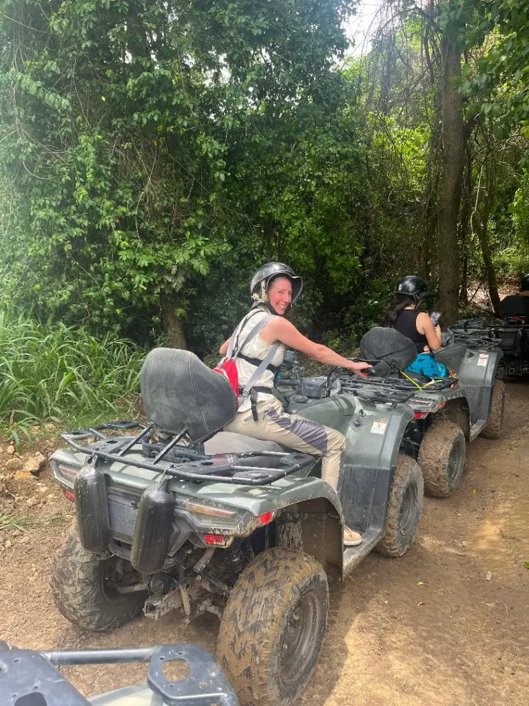 lady facing away from camera on an adventure on an atv with helmet in the jungle in Puerto Rico