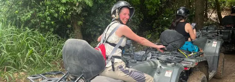 lady facing away from camera on an adventure on an atv with helmet in the jungle in Puerto Rico