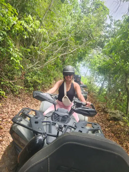 lady having an adventure on an atv with helmet in the jungle in Puerto Rico