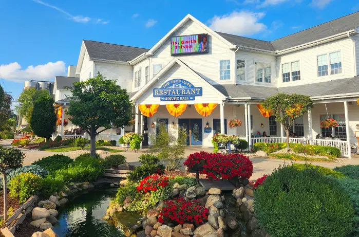 large white building of Blue Gate Restaurant in shipshewana with flowers in front of it