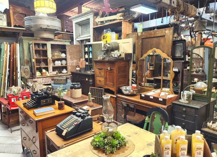 old furniture, jars, typewriters in an antique store in Shipshewana