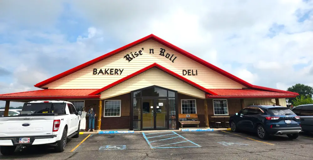 white building with red roof of the Rise and Roll Bakery in Shipshewana