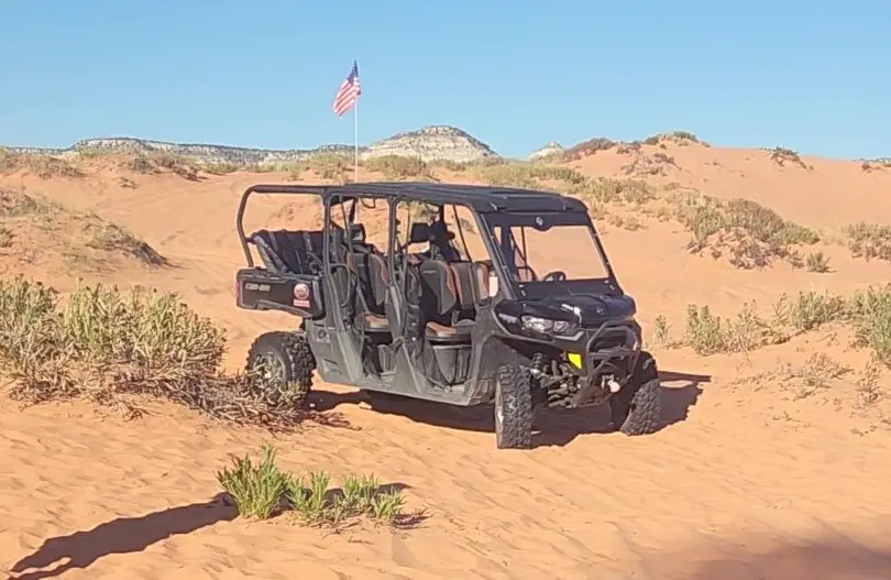 atv vehicle parked in the red sand in kanab utah