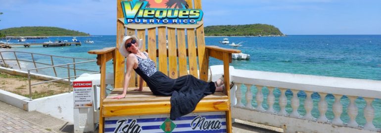 lady in hat and a bathing suit sitting in a chair in front of a water view in Vieques Puerto Rico