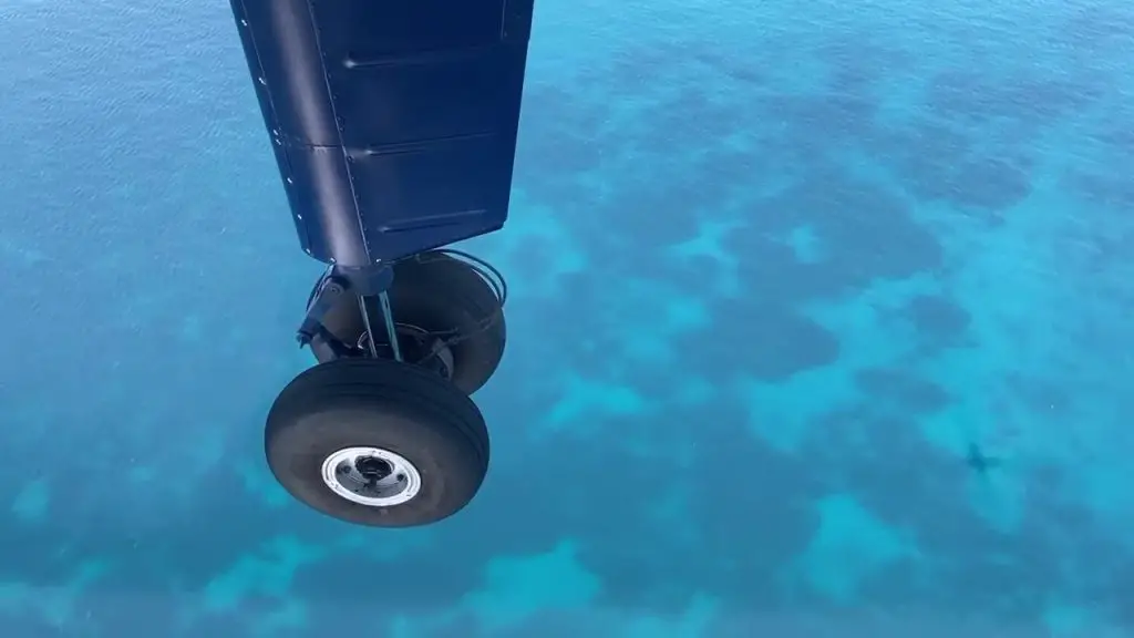 wheel of airplane of blue water