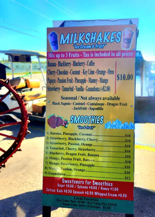 sign listing all the flavors of milkshakes and smoothies at the fruit stand Robert is Here