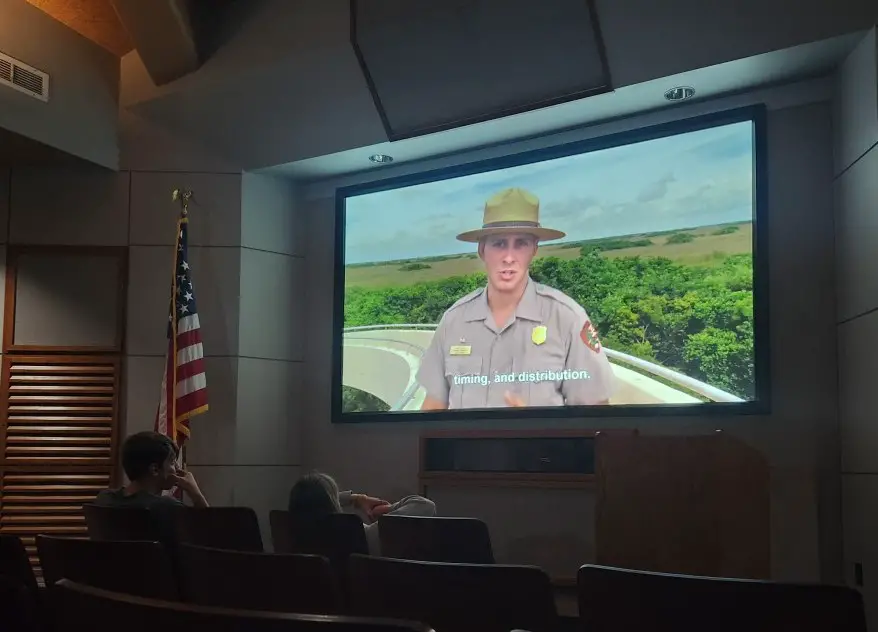ranger on a large tv screen in a dark auditorium 