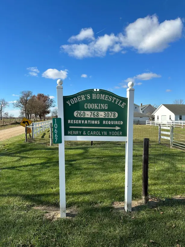 Green Sign in a lawn: Yoder Amish Cooking