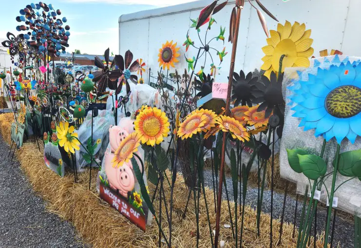 colorful garden decorations sticking out of a platform of hay at the Shipshewana Flea Market