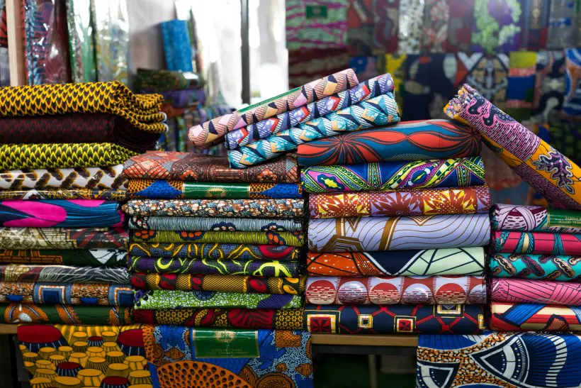 colorful fabrics folded in several piles