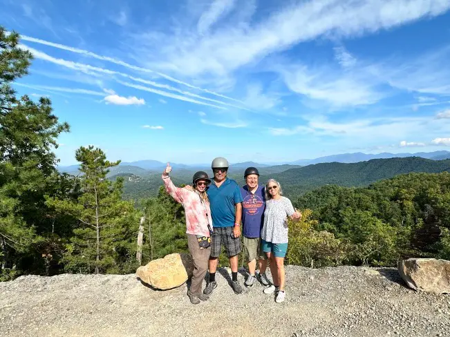 two couples in helmets at the top of a mountain in the mountain scenery in Pigeon Forge TN 