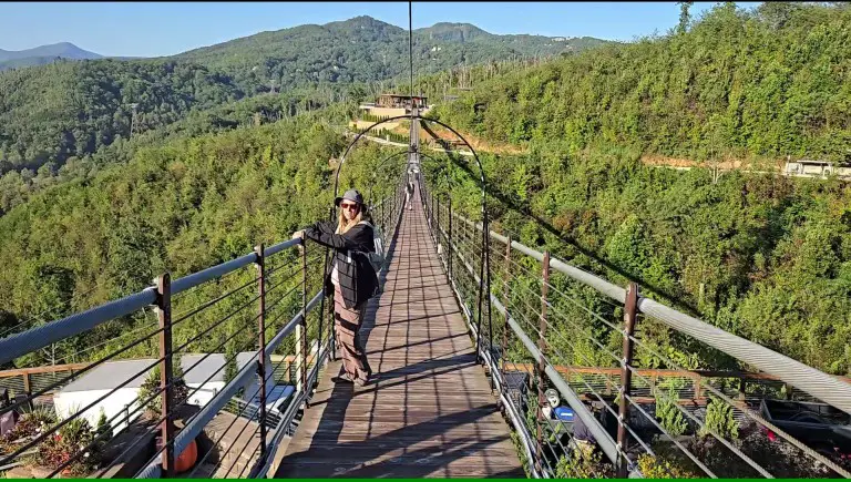 lady standing on a suspension bridge in the mountains at Skypark in Gatlinburg TN