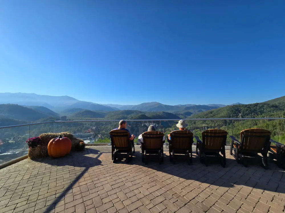 relaxing wooden chairs in front of mountain scenery