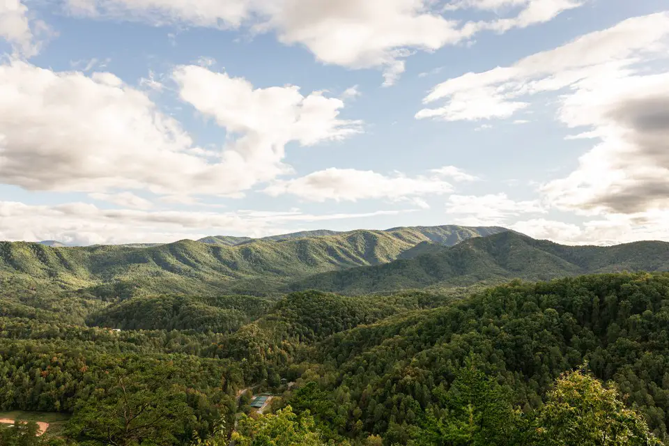 green mountain scenery with a partly cloudy and blue sky