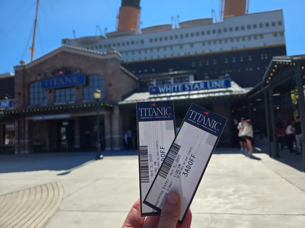 boarding pass tickets in front of a replica of the Titanic Ship