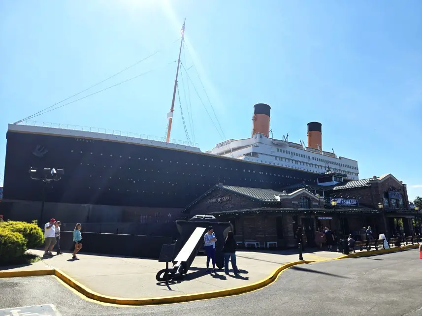 very large ship parked on the sidewalk with people walking in front of it to get inside the Titanic Museum in Pigeon Forge TN