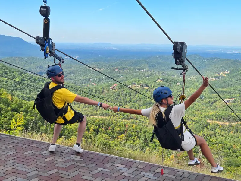 Couple holding hands on a zip line adventure in Pigeon Forge TN